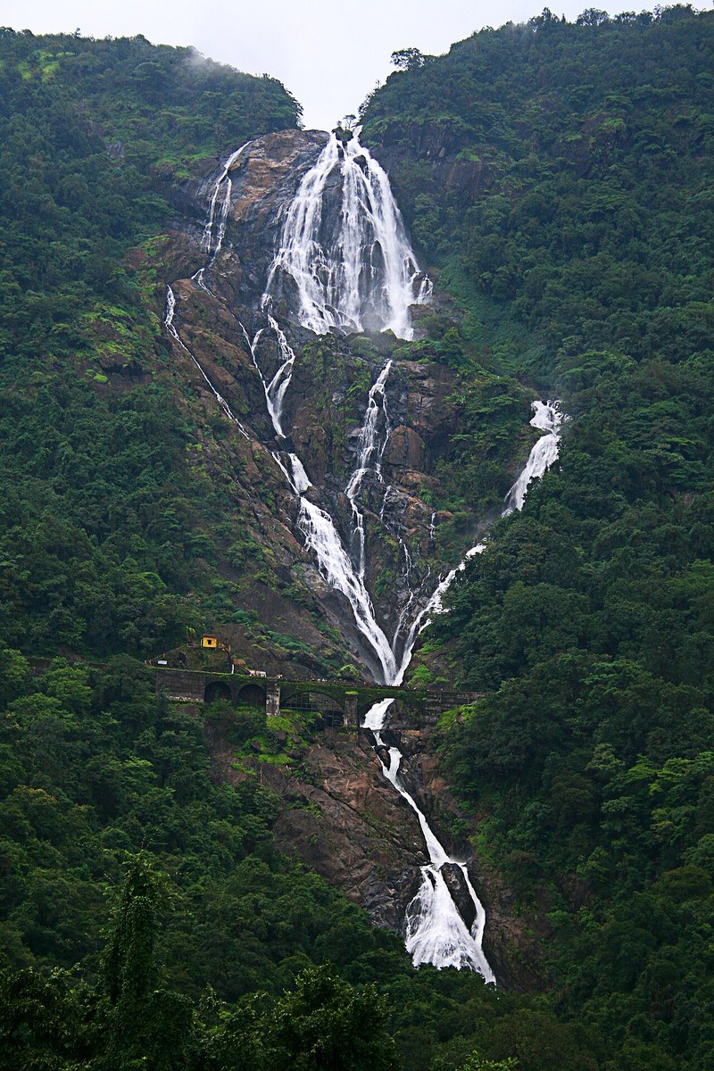 Dudhsagar Falls, a four-tiered waterfall on the Goa-Karnataka border, with a railway viaduct crossing in front of it